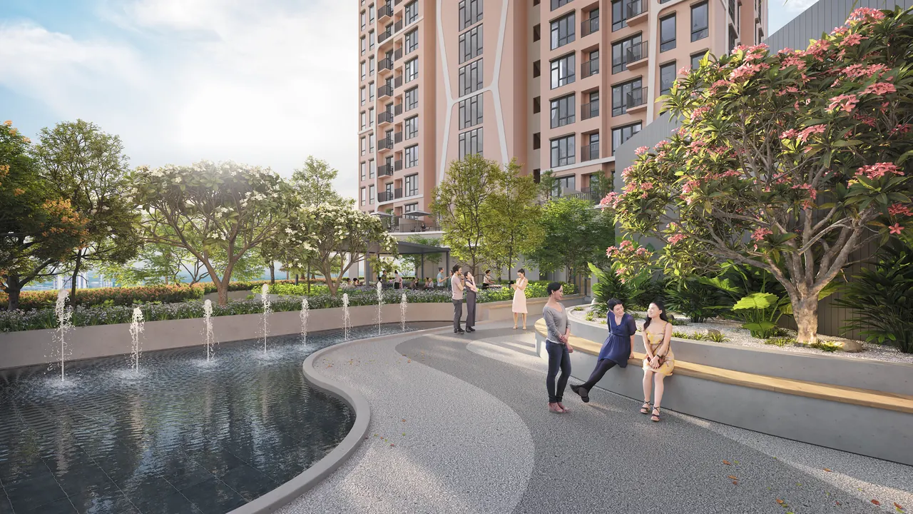 Residents walking the landscaped garden deck at A-SOHO, water feature and mature planting alongside.