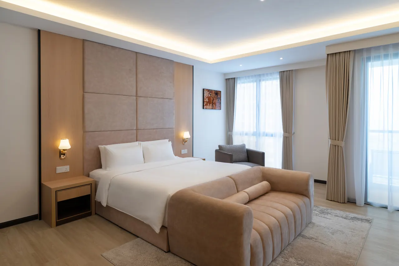 Service suite at Asteria Melaka with the bed facing a full-height window.