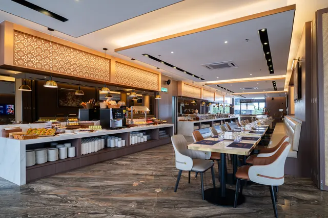 Timber-lined residents' lounge and servery counter at Asteria Melaka.