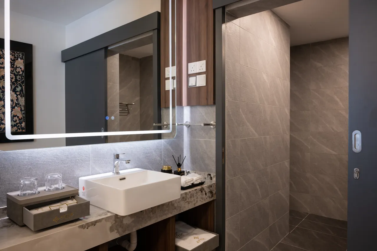 Stone-clad bathroom vanity inside an Asteria Melaka suite.