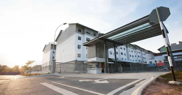 Permas Dormitory's entrance canopy and accommodation blocks in morning light.
